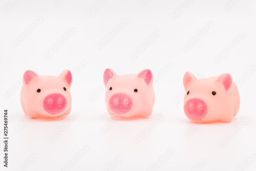 Three little pig fairy tales, three pink cute toy piglets neatly arranged on a white background Three little pig fairy tales, three pink cute toy piglets neatly arranged on a white background