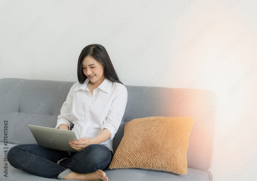 Young woman working business online using laptop  in a comfortable mood.