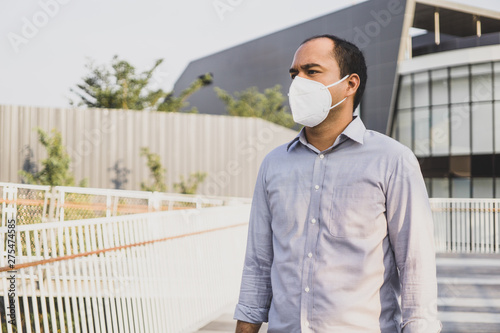 Man wearing facial hygienic mask nose outdoors. Air pollution concept.