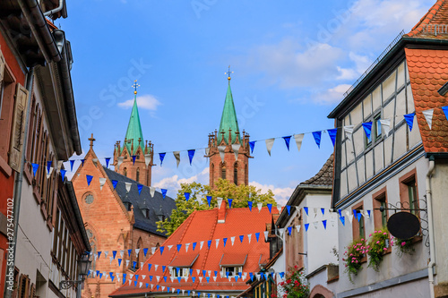 Oktoberfest decoration in the streets of old German town. Street with traditional Houses and Oktoberfest garland