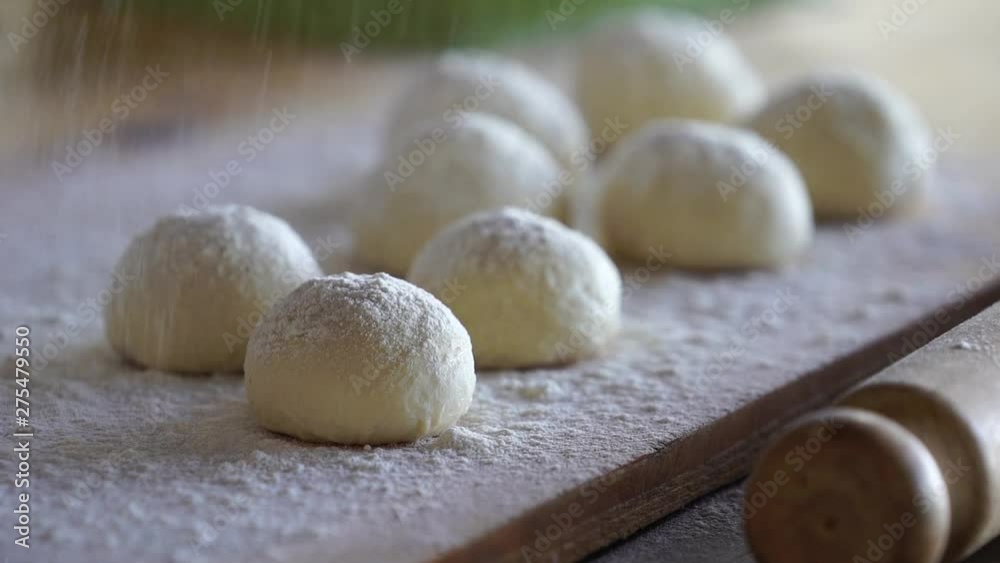 dough balls while flour falls over in slow motion dough balls while flour falls over in slow motion