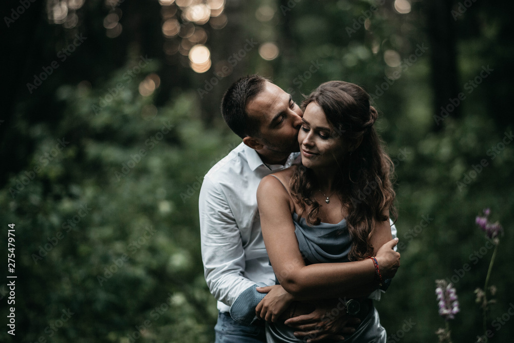 Loving couple in the woods on a romantic date at engagement. The young family is happy in harmony.