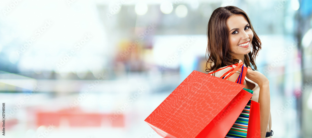 Full-length happy smiling lady with a lot of colourful shopping bags from  the fancy shops. Luxury shopping venue. Stock Photo by ©denisismagilov  74600157