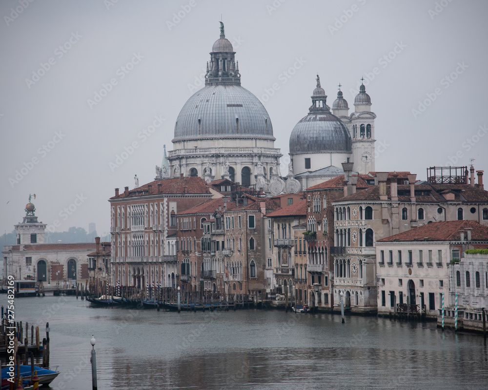 Grand Canal and the island of Santa Maria della Salute with the Dogana from the Accademia bridge in Venice, Italy. Widespread dawn light on the lagoon.