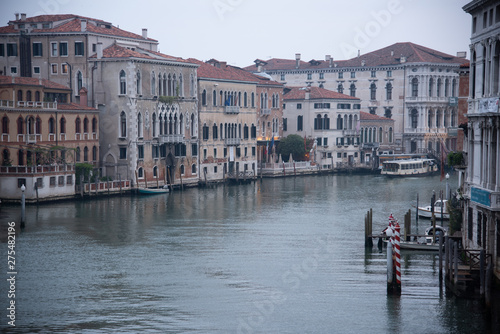 Grand Canal from the Accademia bridge in Venice, Italy. Dawn light spread over the lagoon with a view of the old houses and the ferry. Widespread dawn light on the Venetian lagoon. © Roza_Sean