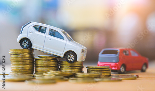 Car and stack of coin. Saving money for car concept. Car finance, buy car new concept. photo