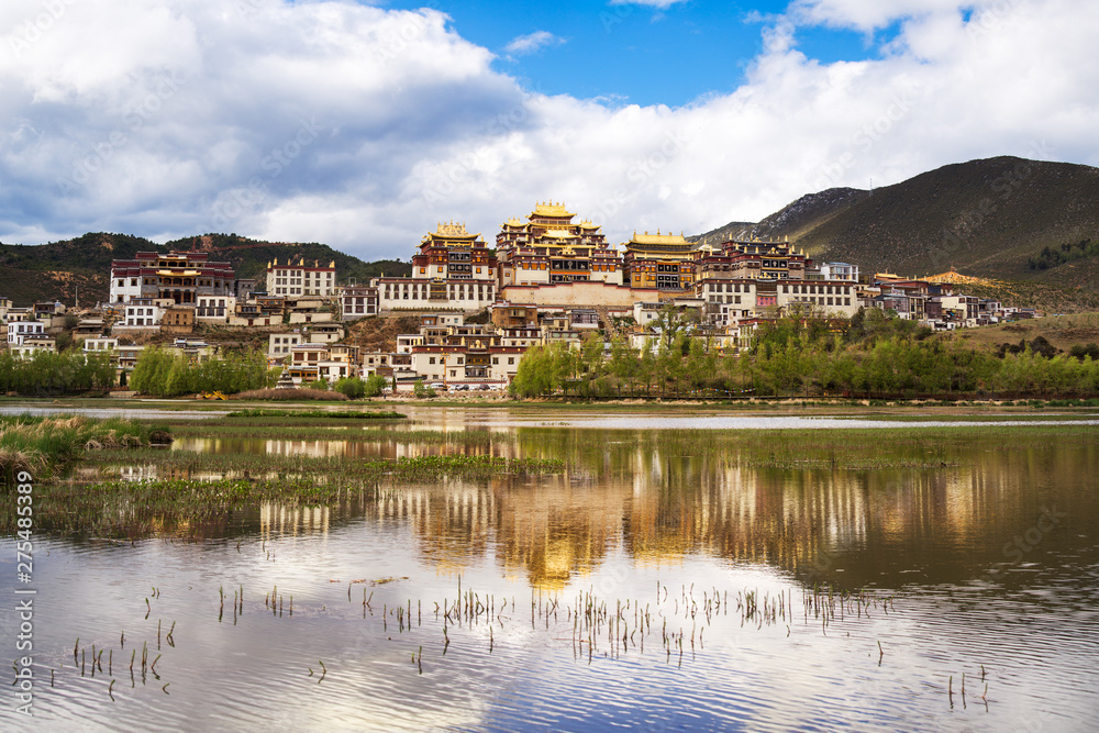 Tibetan monastery of shangri-la. China.Yunnan. Reflected in the lake
