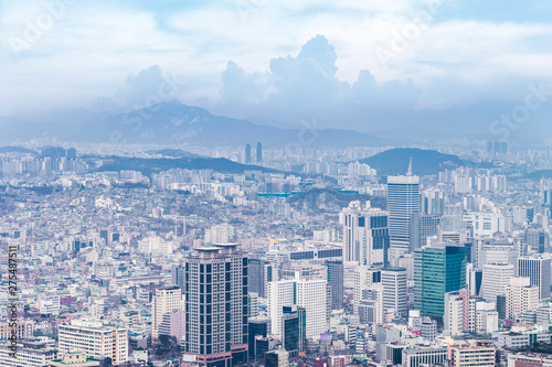 Seoul cityscapes, skyline, high rise office buildings and skyscrapers in Seoul city, winter daylight, top view in winter, Seoul, Republic of Korea, in mist winter season with blue sky and cloud