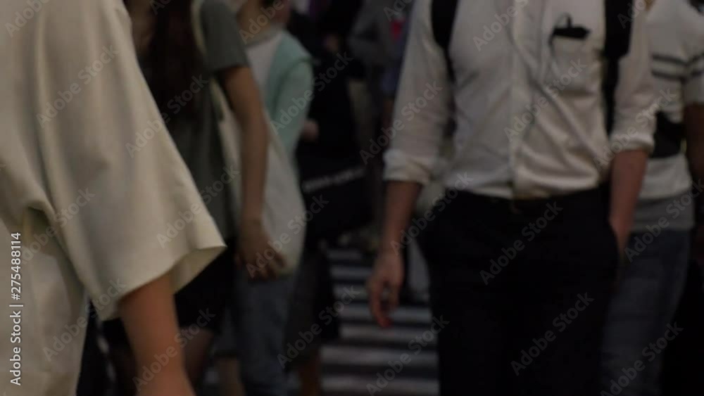 SHINJUKU, TOKYO, JAPAN - CIRCA JUNE 2019 : View of crowd of people walking down the street in busy rush hour. Many commuter walking to the train station after work. Shot in early evening. Defocus shot SHINJUKU, TOKYO, JAPAN - CIRCA JUNE 2019 : View of crowd of people walking down the street in busy rush hour. Many commuter walking to the train station after work. Shot in early evening. Defocus shot