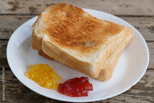 roasted bread with orange and strawberry jam