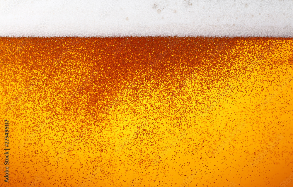 Close up background of beer with bubbles in glass Close up background of beer with bubbles in glass