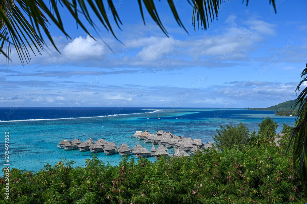 Huts over tropical reef, Moorea, French Polynesia