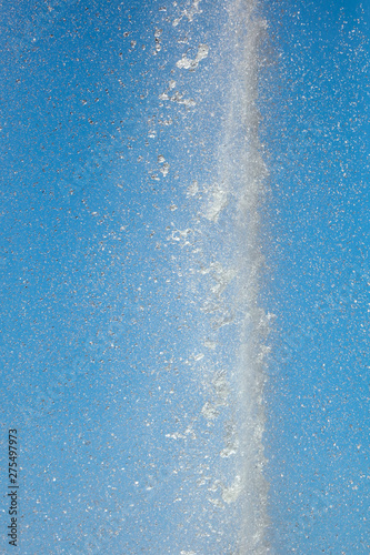 Fototapeta Naklejka Na Ścianę i Meble -  Splashes of water against the blue sky