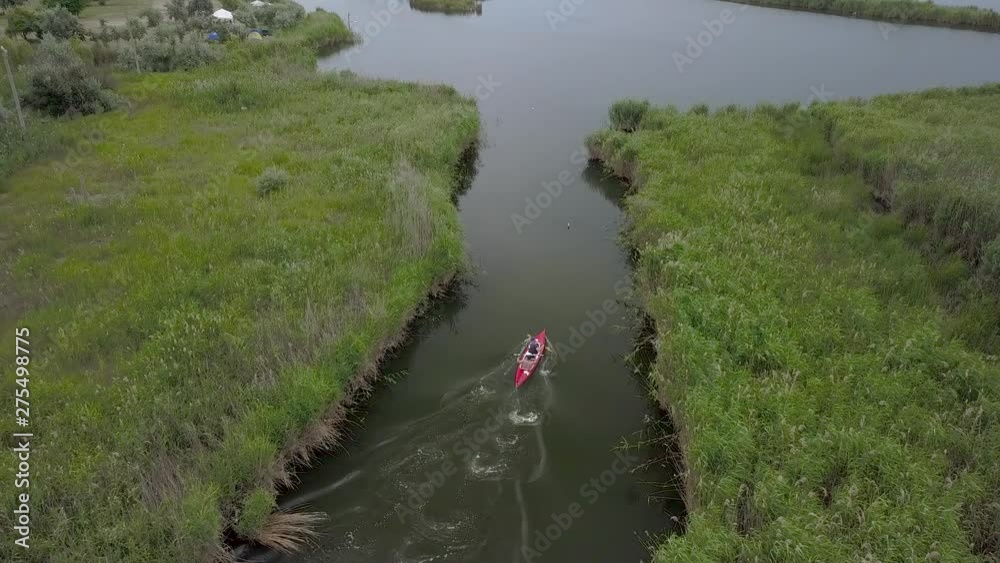 Aerial View of Kayak sailing on the river among the reeds. 4K Aerial View of Kayak sailing on the river among the reeds. 4K