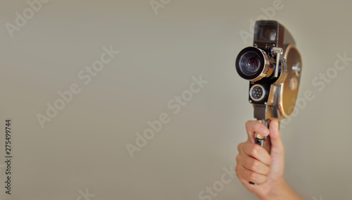 Hand holding vintage old movie camera with copy space