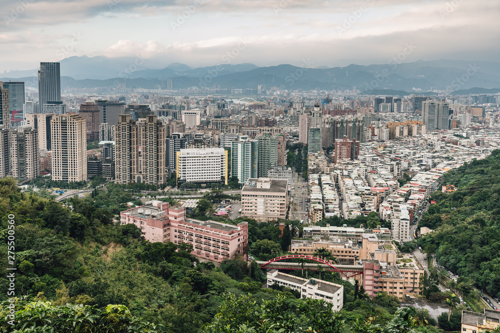Aerial panorama over Downtown Taipei with layers of mountain in background in the dusk from Xiangshan Elephant Mountain in the evening.