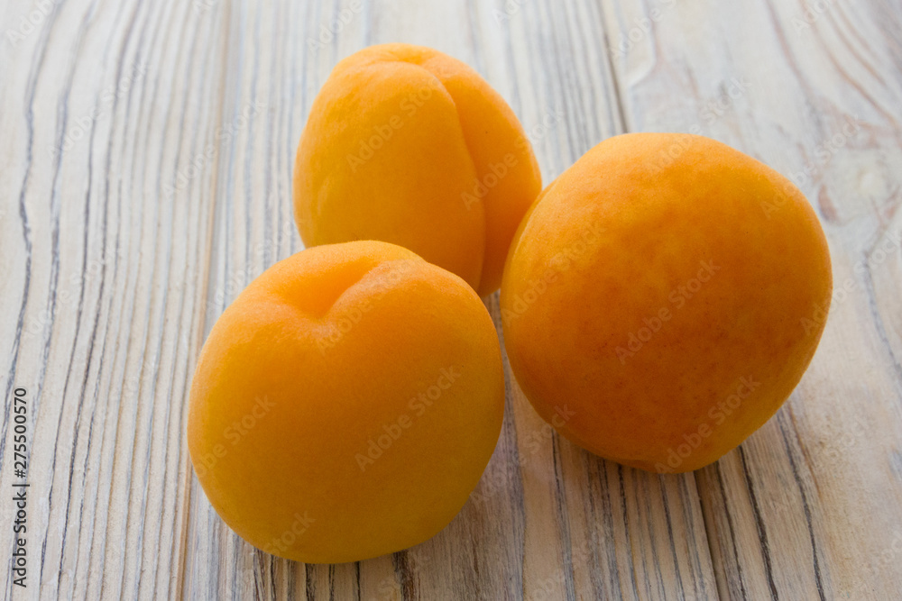 Apricot fruits group on the wooden background Apricot fruits group on the wooden background