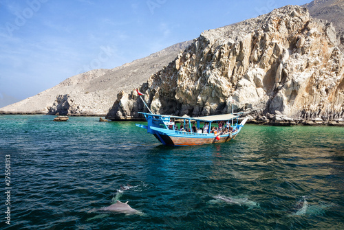 Khasab, Oman: Tourist seeing dolphins from boat. photo