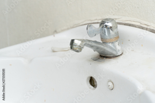 Close-up of old chrome water tap, bathroom sink