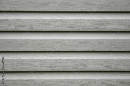 a fragment of a house wall trimmed with siding