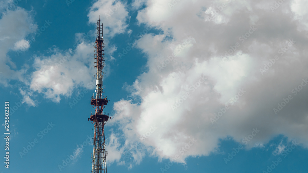 telecommunication radio tower on the vast blue sky background. White clouds on sky. telecommunication radio tower on the vast blue sky background. White clouds on sky.