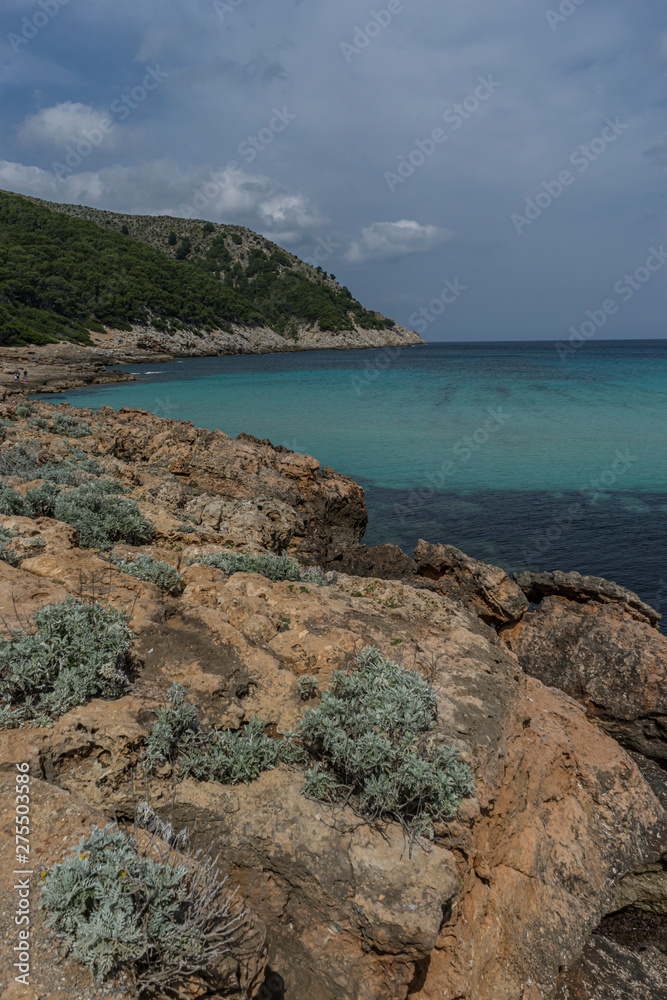 Mediterranean sea crashing against the rocks of the Spanish island of Mallorca, Ibiza, Spain.