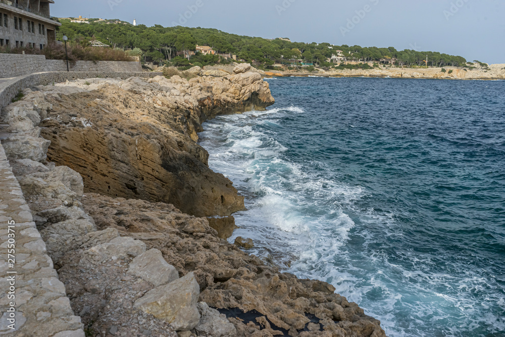 Travel summer, Mediterranean sea crashing against the rocks of the Spanish island of Mallorca, Ibiza, Spain.