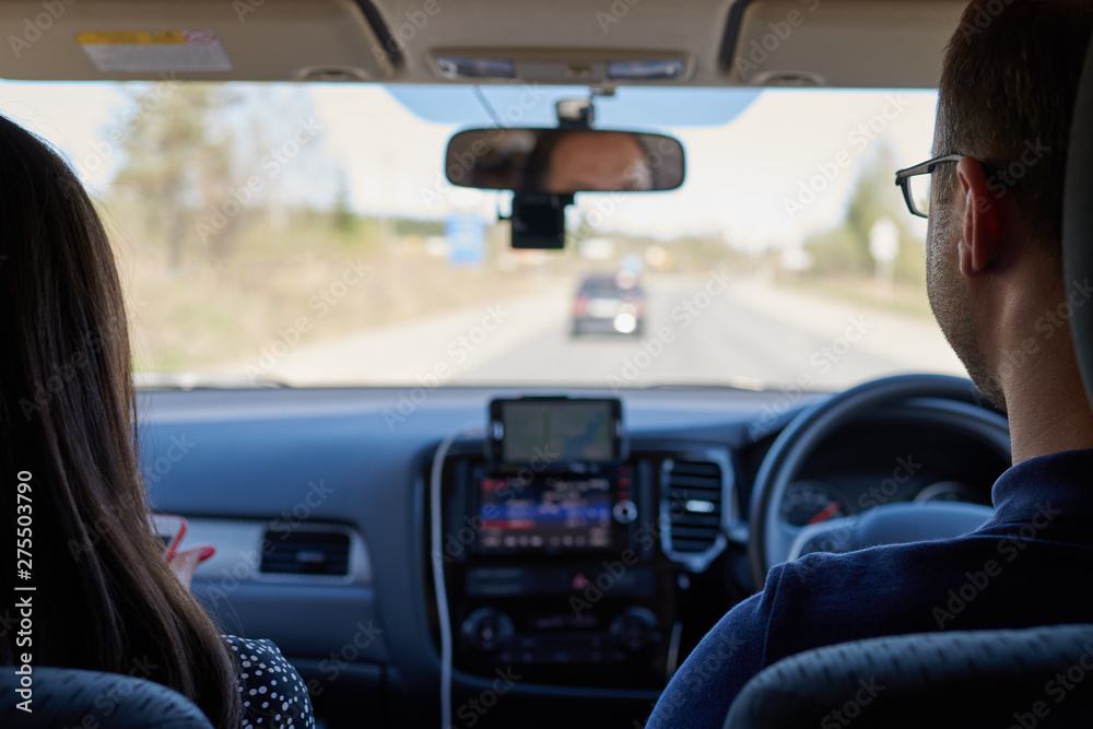 Young European couple is moving in the car along countryside road, they a searching for a right way. Young European couple is moving in the car along countryside road, they a searching for a right way.