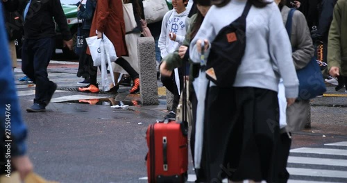 Legs of walking people at the crossing rainy day. Shibuya district Tokyo Japan - 04.30.2019 : It is a center of the city in tokyo. camera : Canon EOS 5D mark4 photo