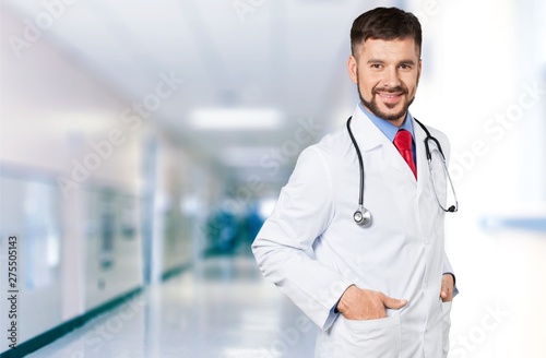 Young doctor man with stethoscope in clinic