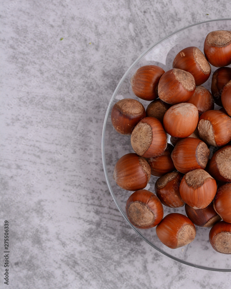 Nuts. Heap of hazelnuts on a plate. Top view. Close-up. Food photography.