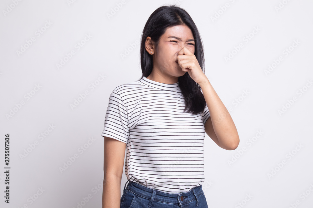 Young Asian woman holding her nose because of a bad smell. Young Asian woman holding her nose because of a bad smell.