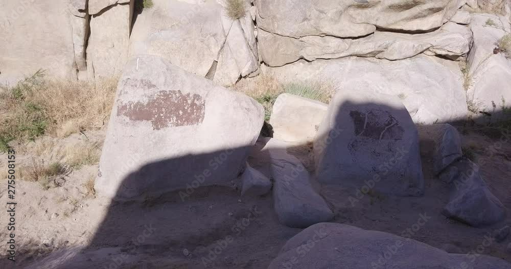 aerial drone orbiting sjot around boulders in the shadow with Petroglyphs,Coyote Hole Spring Canyon , Joshua tree, Yucca Valley, California