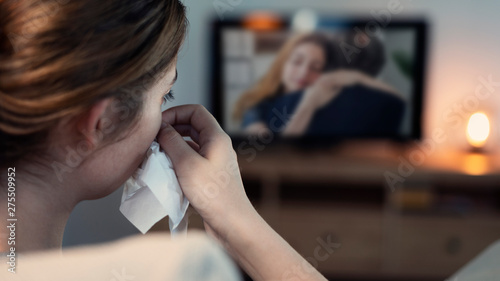 Fotografering Woman crying while watching tv in the night
