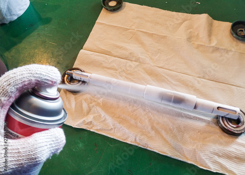 Penetrant Test , worker apply developer to the shaft for finding the defect.