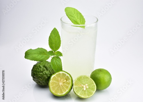 Bergamot , sweet basil and lime mixed with soda in a glass and sweet basil leaves placed on the glass.