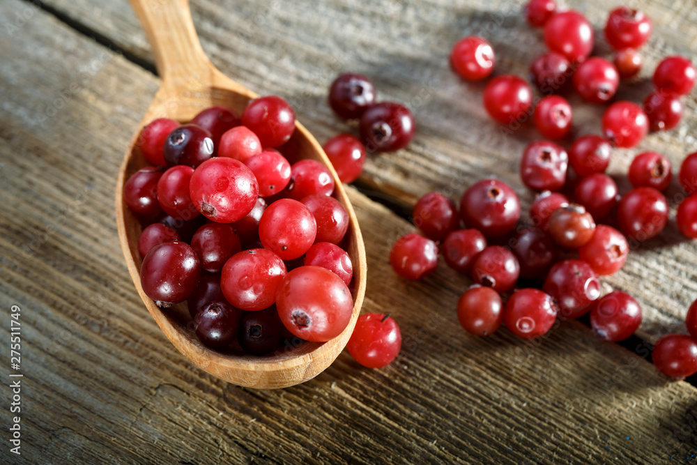 Cranberries in a wooden spoon. Cranberries in a wooden spoon.