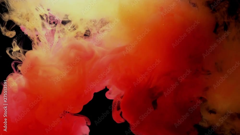 Color splashes of ink isolated on black background. Abstract paint in water, photographed in motion. Swirling colorful drops cloud. Color splashes of ink isolated on black background. Abstract paint in water, photographed in motion. Swirling colorful drops cloud.