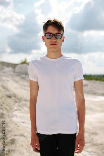 Handsome model man wearing white blank t-shirt with space for your logo or design.