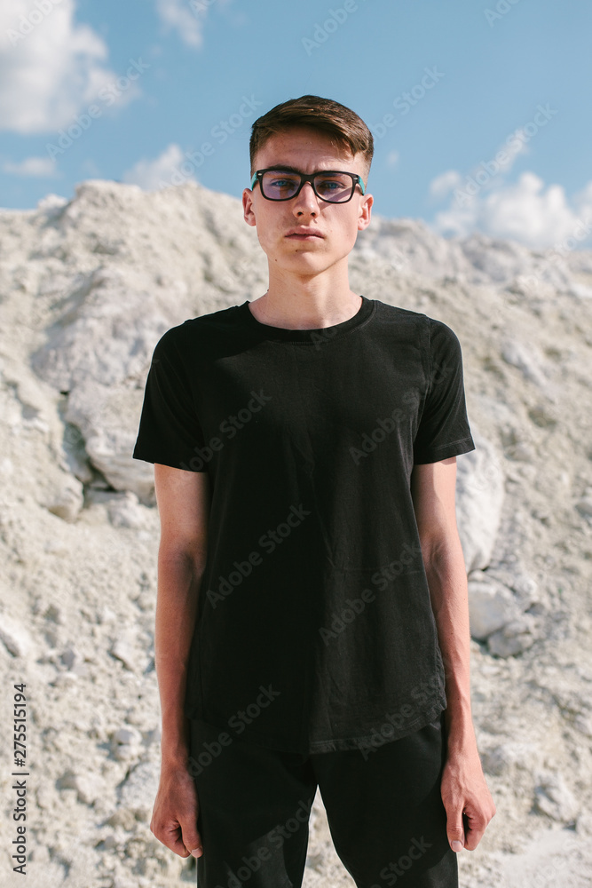 Handsome model man wearing black blank t-shirt with space for your logo or design.