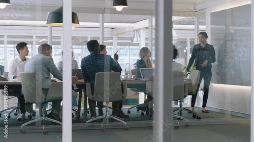 group of business people meeting in boardroom team leader woman presenting ideas on whiteboard discussing strategy with colleagues in office training presentation 4k