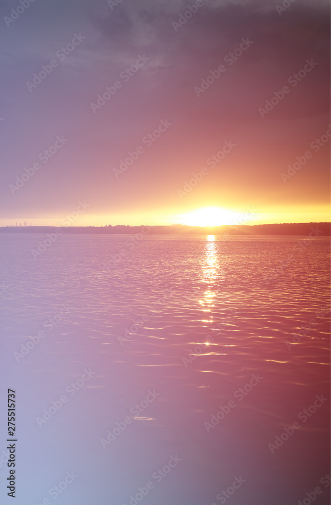 Fototapeta premium Vertical sunset on river with dramatic light leak landscape