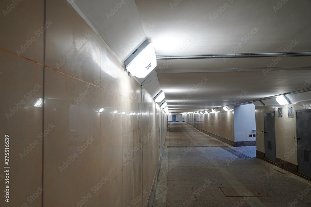 Modern pedestrian tunnel empty without people. Underpass new with light. Beige color.