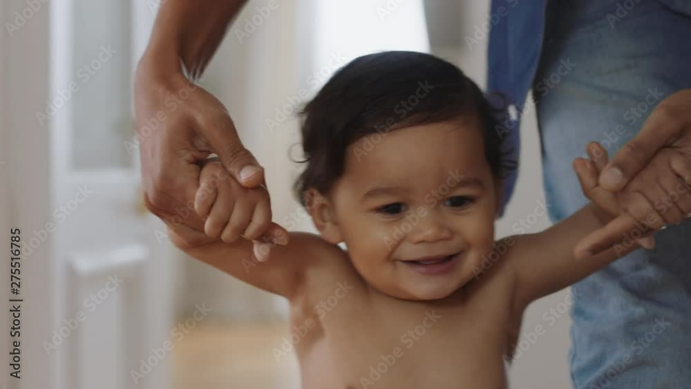 happy baby learning to walk toddler taking first steps with father helping infant teaching child at home happy baby learning to walk toddler taking first steps with father helping infant teaching child at home