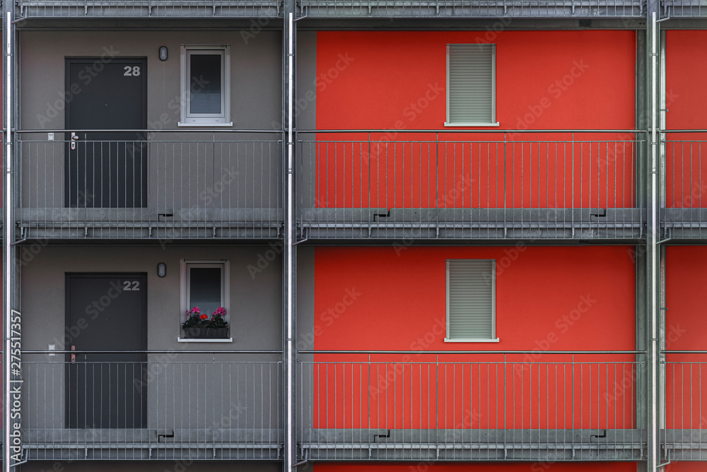Gray and red apartment building exterior close-up Gray and red apartment building exterior close-up