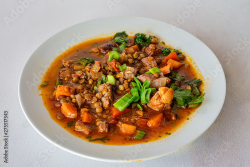 Rich lentil stew with pork and vegetables.