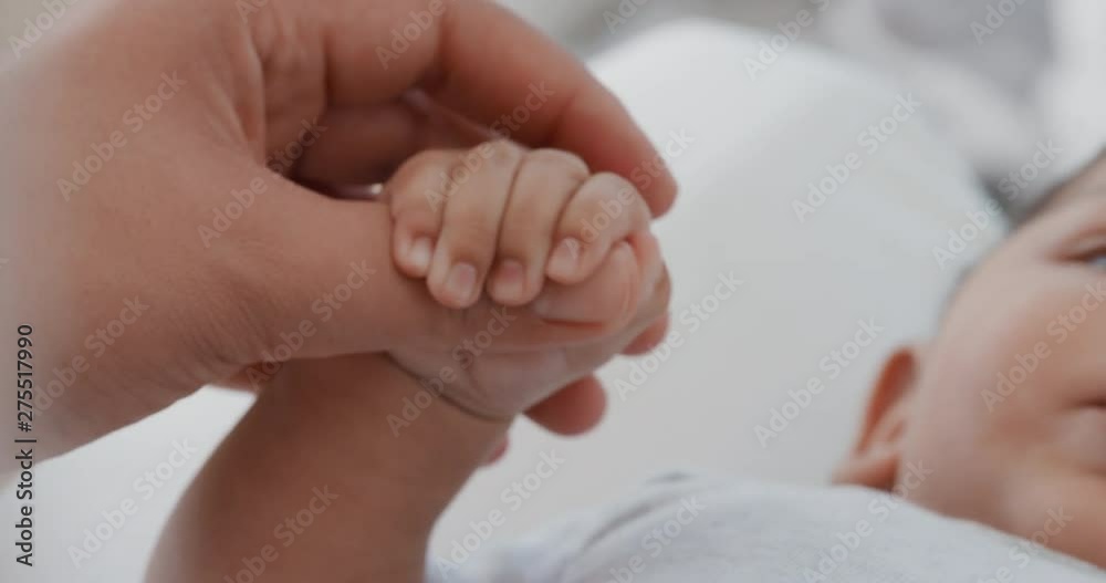 close up mother holding baby hand touching fingers mom nurturing newborn caring for infant at home motherhood love 4k close up mother holding baby hand touching fingers mom nurturing newborn caring for infant at home motherhood love 4k