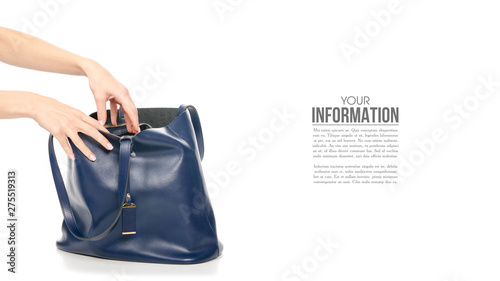 Woman's female blue leather bag in hand, sample text on white background isolation