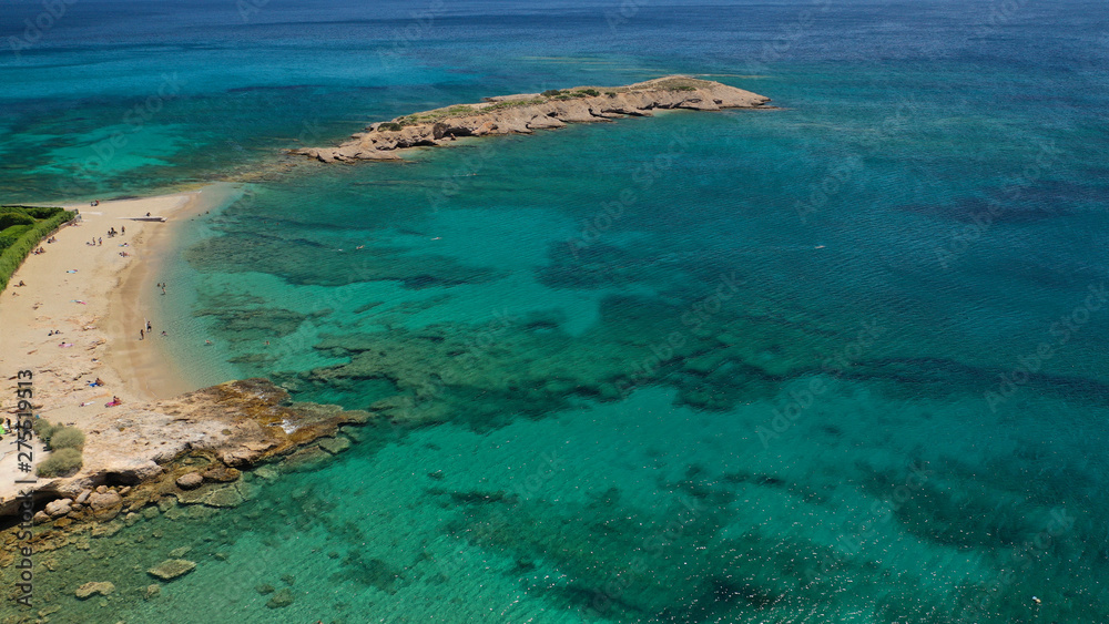Aerial photo of not so famous Akrotiri Lovardas beach and small islet with caves and clear turquoise sea, Athens riviera, Attica, Greece