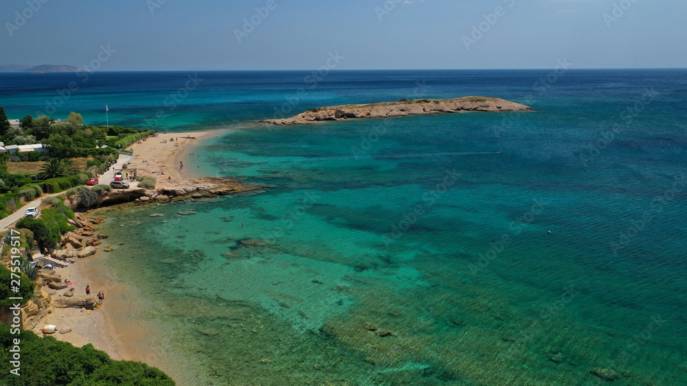 Aerial photo of not so famous Akrotiri Lovardas beach and small islet with caves and clear turquoise sea, Athens riviera, Attica, Greece